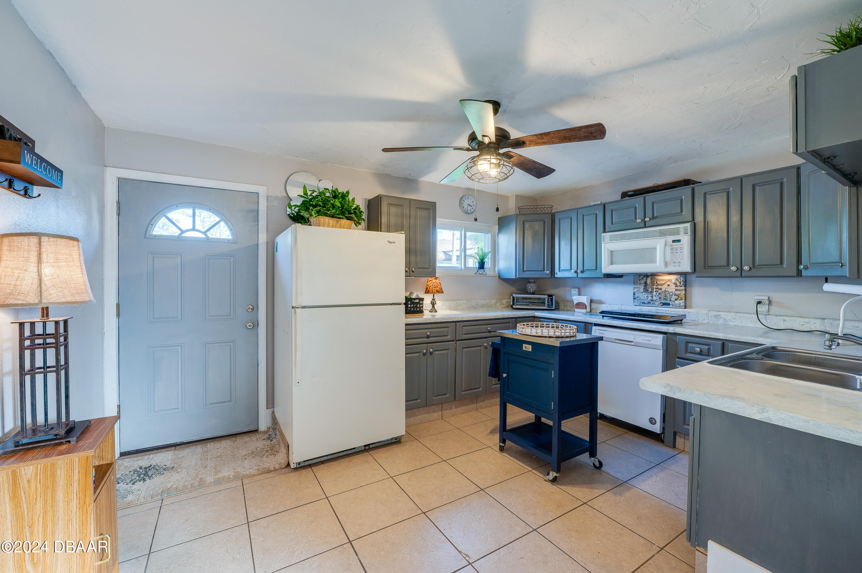 4850 Spruce Creek Road Port Orange, FL 32127 - Photo 19 of 27 a kitchen with a refrigerator a sink and dishwasher