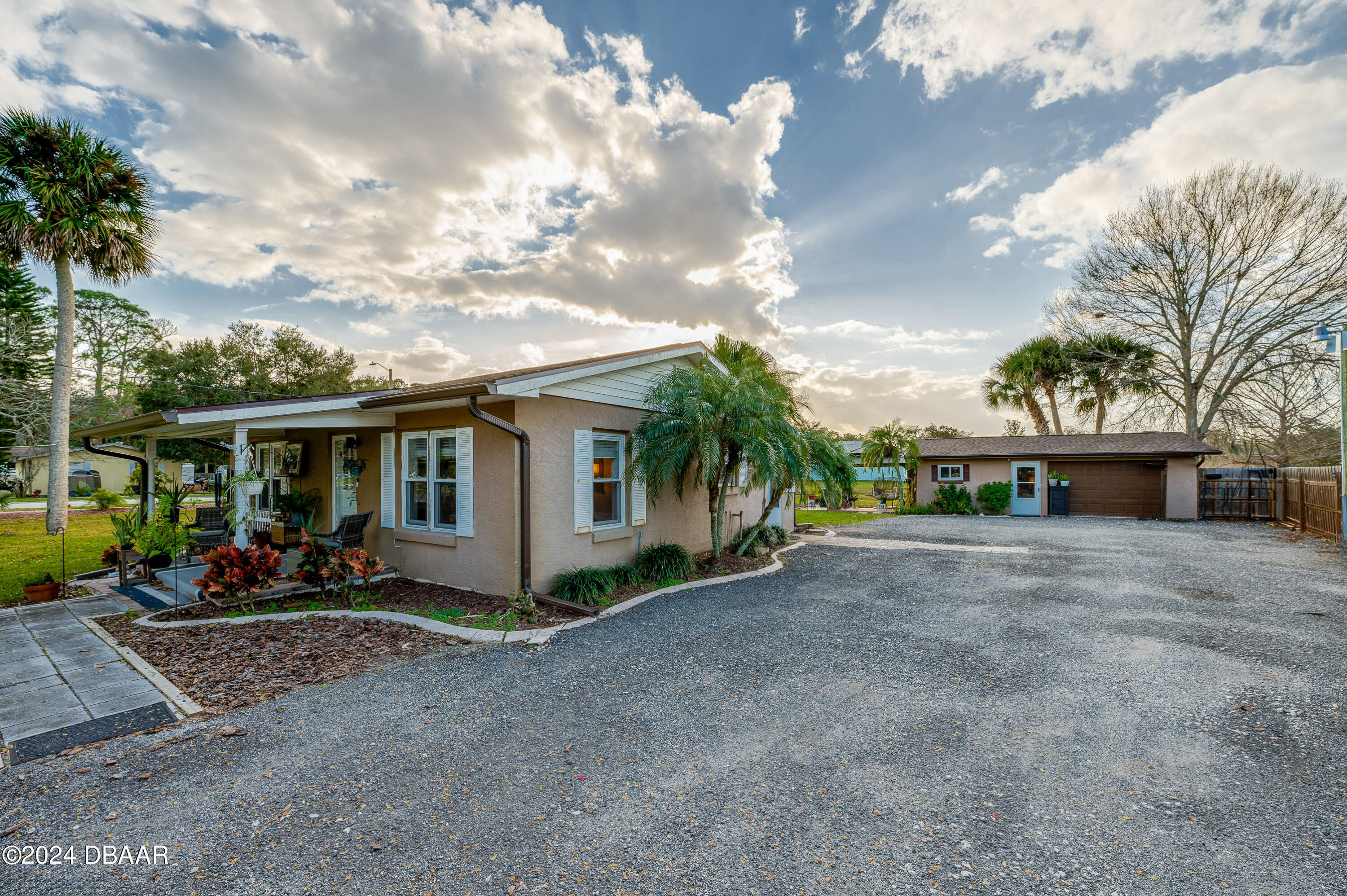 4850 Spruce Creek Road Port Orange, FL 32127 - Photo 2 of 27 a front view of a house with garden