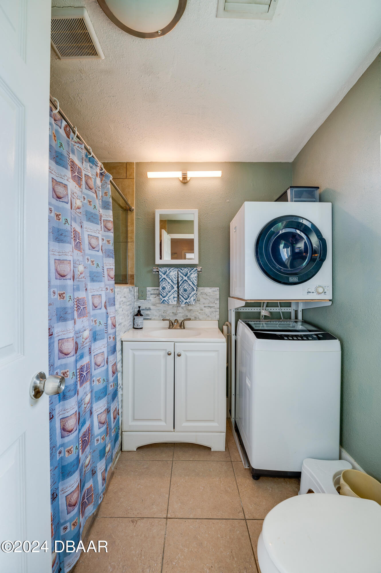 4850 Spruce Creek Road Port Orange, FL 32127 - Photo 23 of 27 a bathroom with a sink a mirror and a toilet