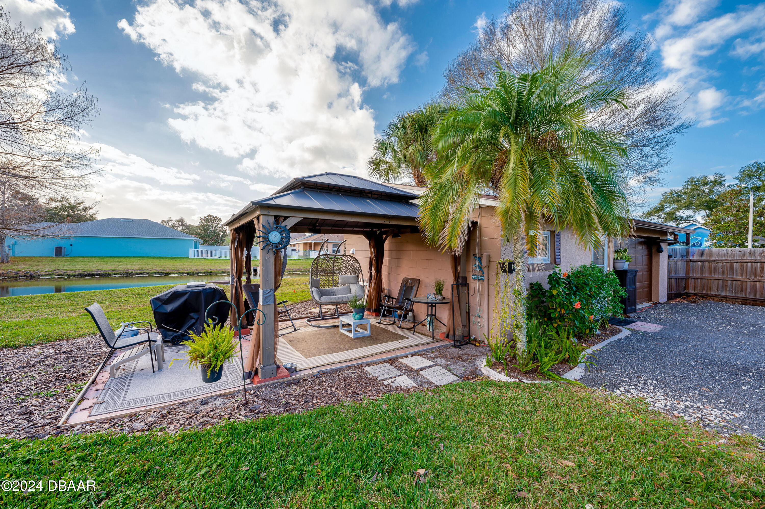 4850 Spruce Creek Road Port Orange, FL 32127 - Photo 24 of 27 a view of a backyard with sitting area and slide
