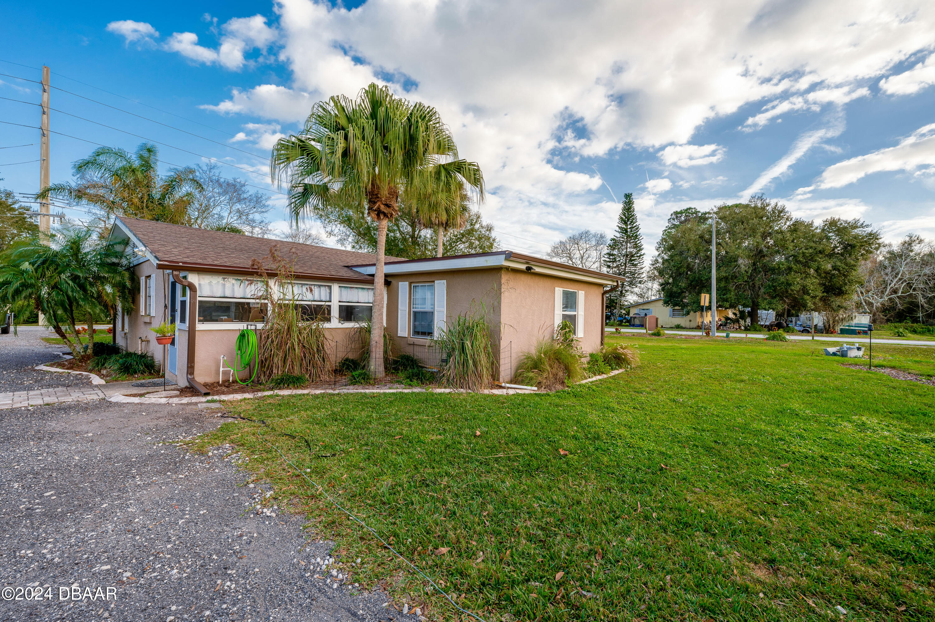 4850 Spruce Creek Road Port Orange, FL 32127 - Photo 25 of 27 a front view of a house with a yard
