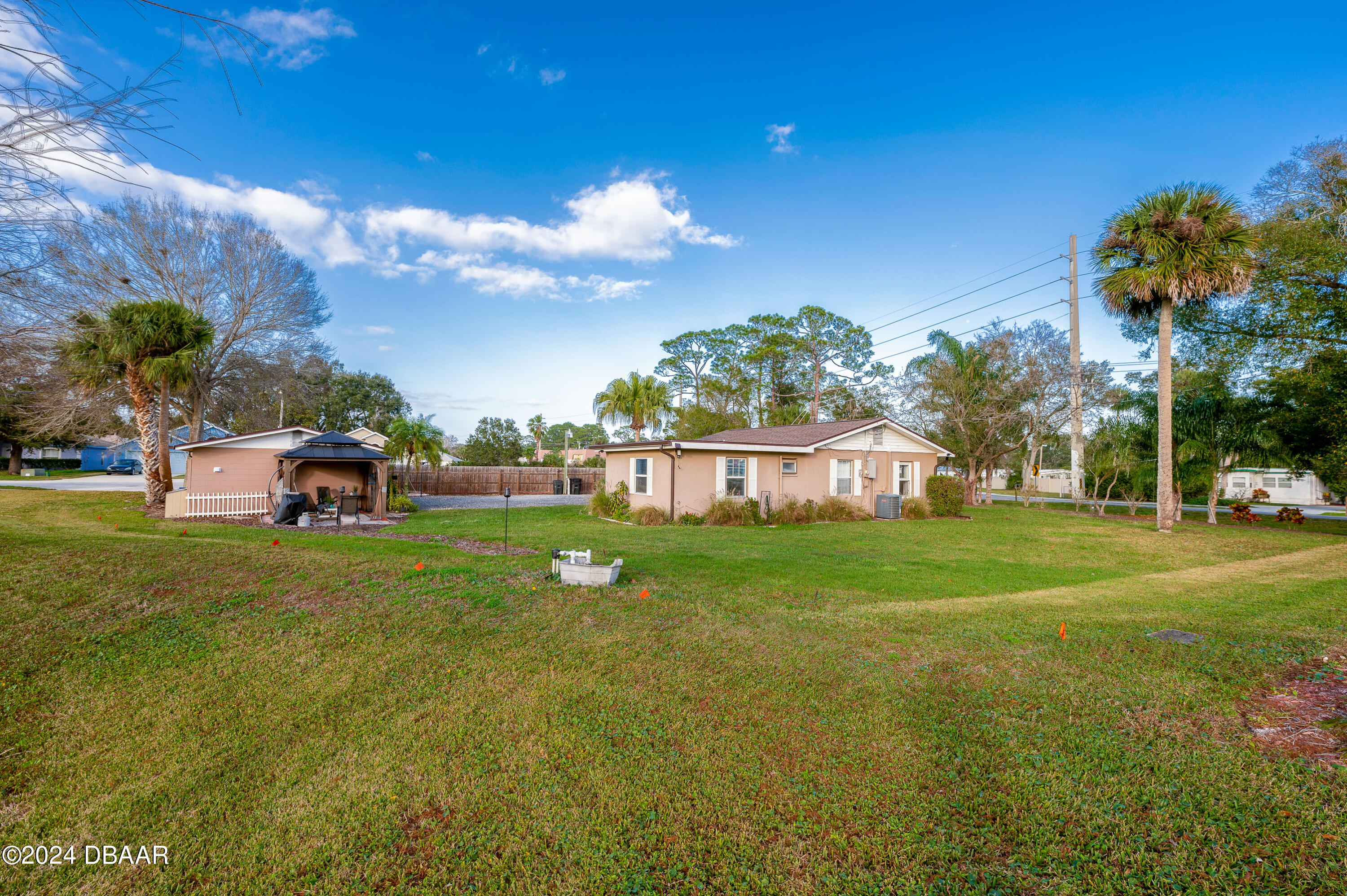 4850 Spruce Creek Road Port Orange, FL 32127 - Photo 26 of 27 a view of a house with a big yard