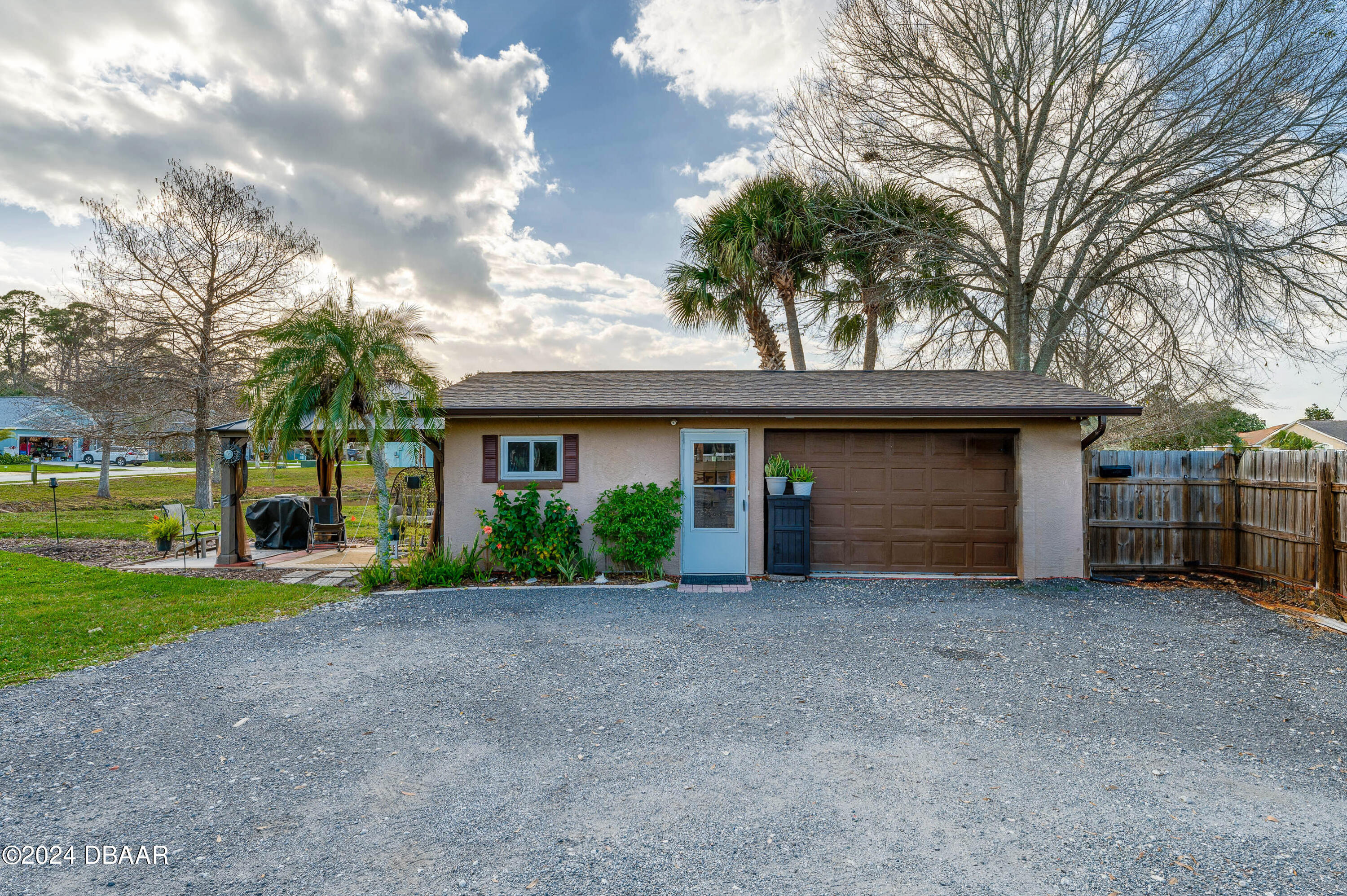 4850 Spruce Creek Road Port Orange, FL 32127 - Photo 4 of 27 a view of a house with a yard and garage