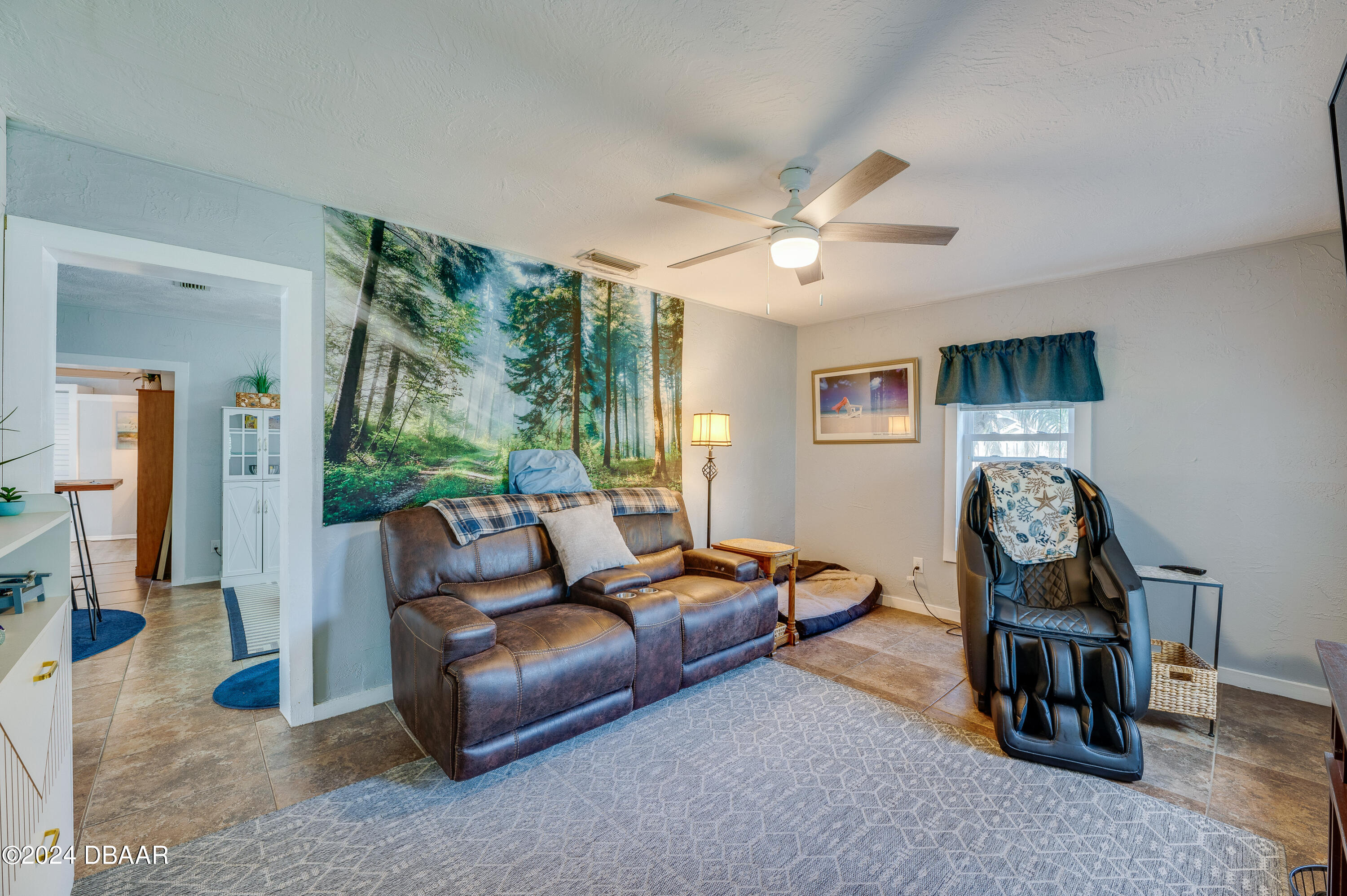 4850 Spruce Creek Road Port Orange, FL 32127 - Photo 5 of 27 a living room with furniture and a chandelier