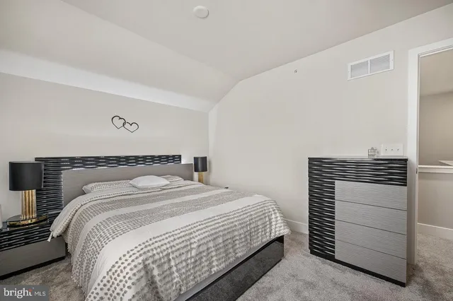 a bedroom with a bed and a dresser