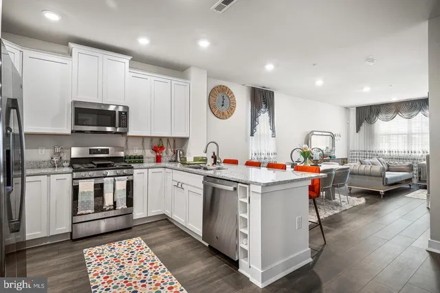 a kitchen that has a lot of cabinets in it and appliances