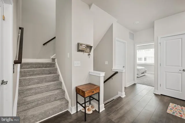 a view of entryway and hall with wooden floor