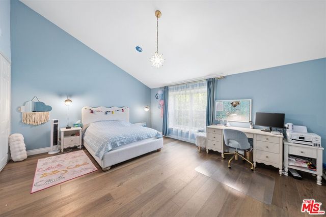 a bedroom with a bed and a desk