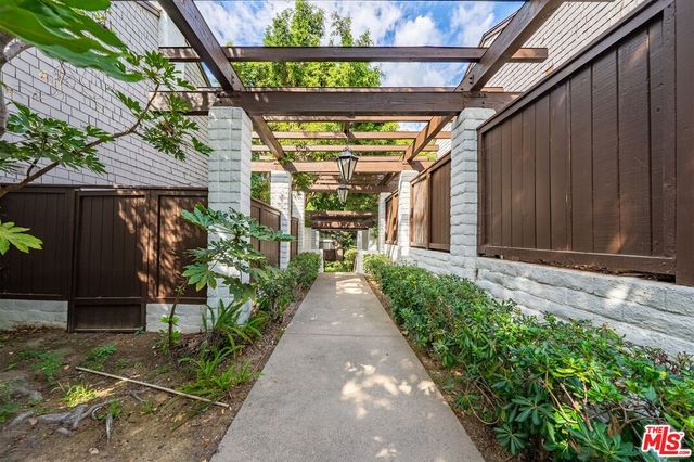 a view of a pathway with an yellow umbrella