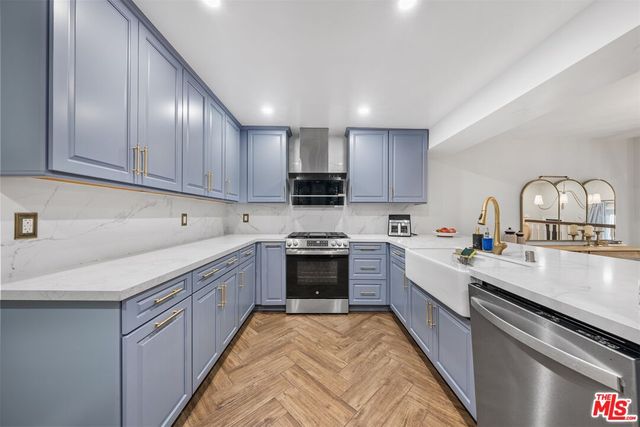 a large kitchen with stainless steel appliances granite countertop a stove sink and cabinets