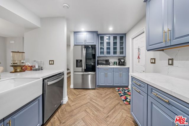 a kitchen with a sink stove and refrigerator