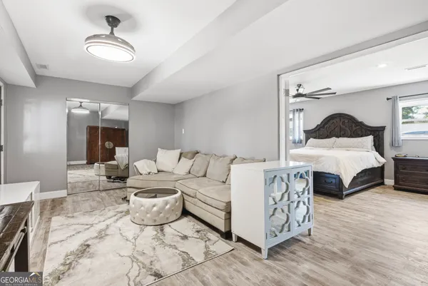 a living room with furniture and a mirror