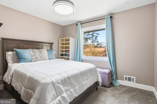 a bedroom with a bed and window