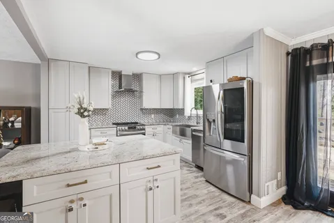 a kitchen with stainless steel appliances granite countertop a refrigerator and a sink