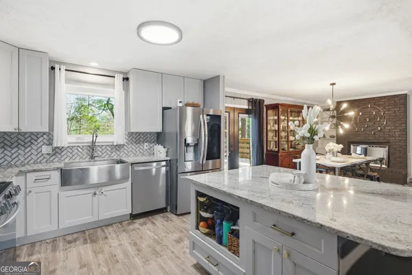 a kitchen with stainless steel appliances granite countertop a sink stove and refrigerator