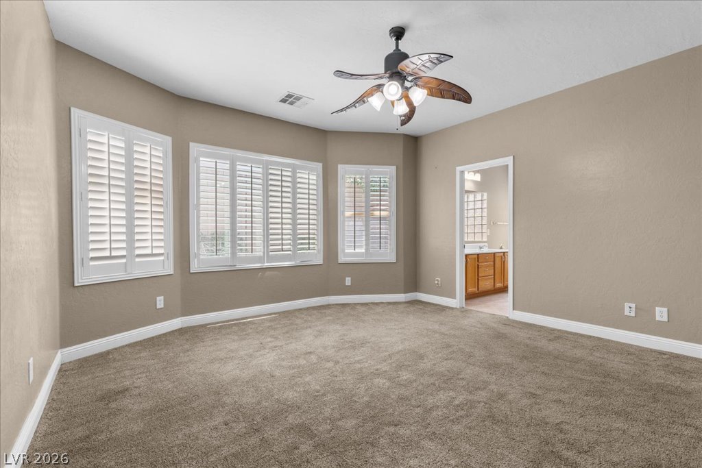 2627 Dirleton Place Henderson, NV 89044 - Photo 19 of 42 Your private retreat awaits! The spacious primary suite is thoughtfully separated from the secondary bedrooms for added privacy.