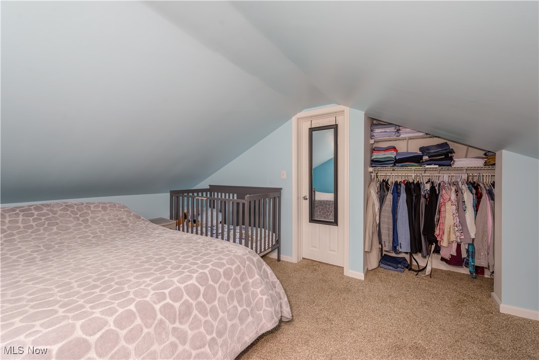 4051 Stow Road Stow, OH 44224 - Photo 26 of 38 Carpeted bedroom featuring a closet and lofted ceiling