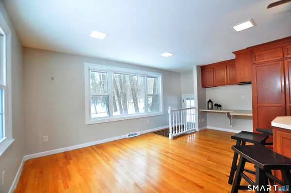 a room with a bed and furniture with wooden floor