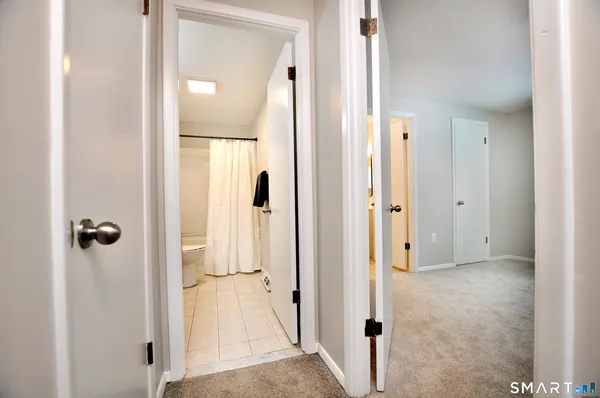 a bathroom with a sink vanity mirror and toilet