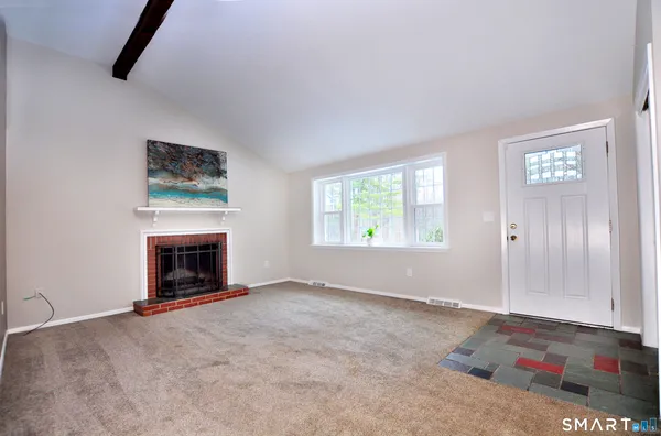an empty room with windows fire place and fireplace