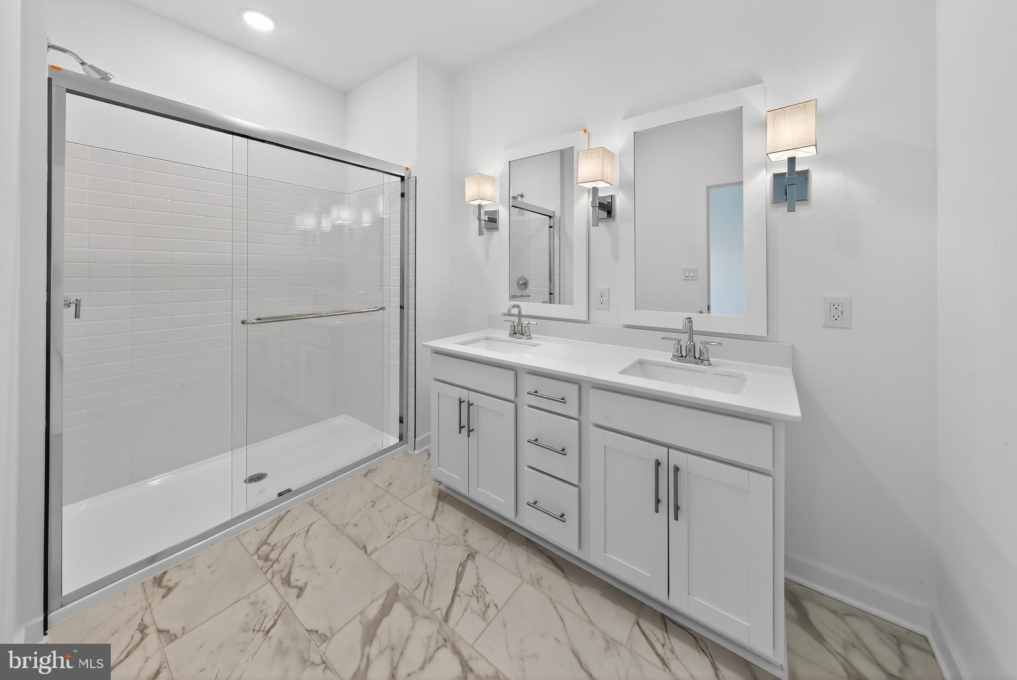 14966 Channel Run Ellendale, DE 19941 - Photo 15 of 21 a bathroom with a shower sink and mirror