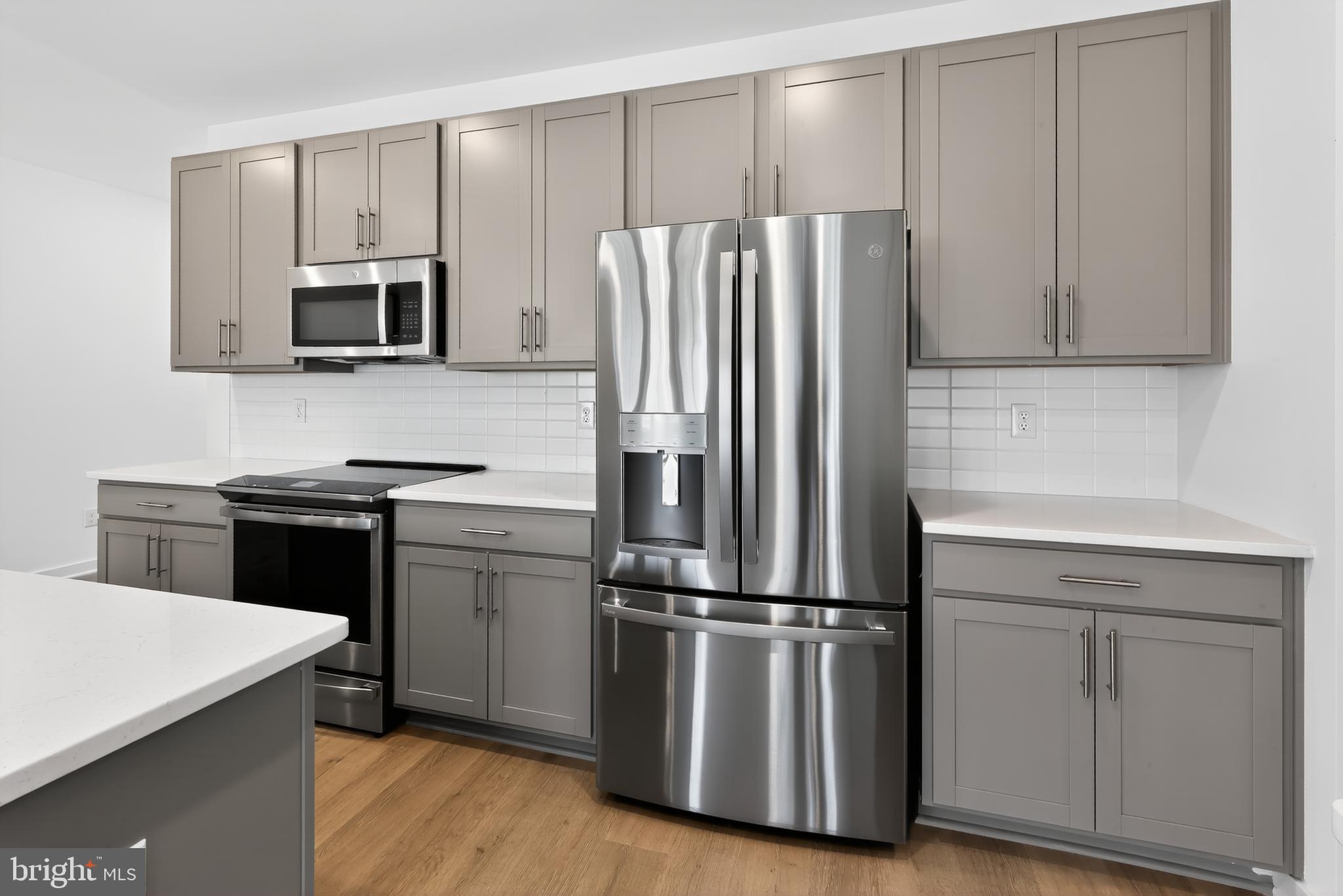 14966 Channel Run Ellendale, DE 19941 - Photo 5 of 21 a kitchen with a refrigerator sink and microwave