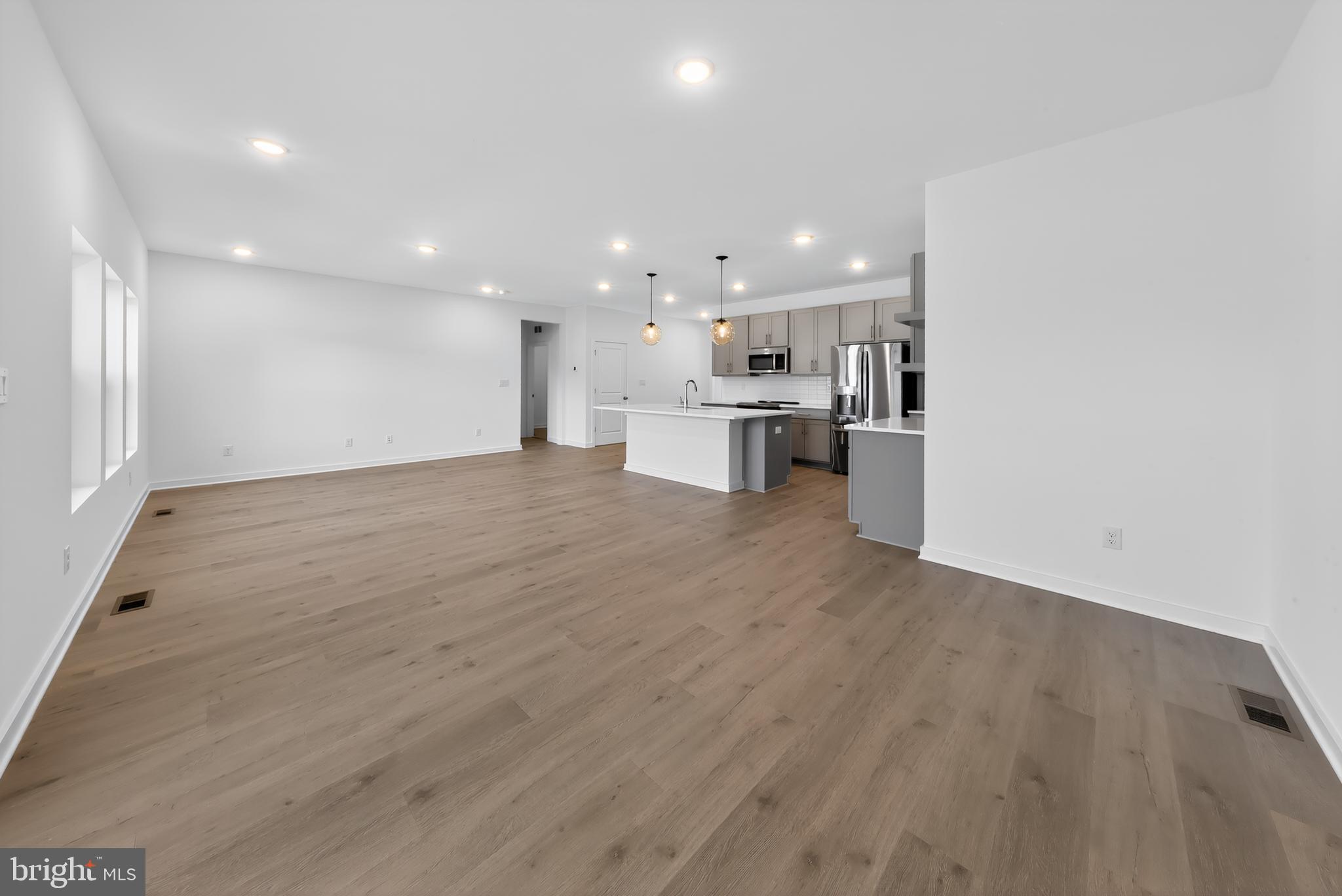 14966 Channel Run Ellendale, DE 19941 - Photo 9 of 21 a view of a kitchen with wooden floor and a sink
