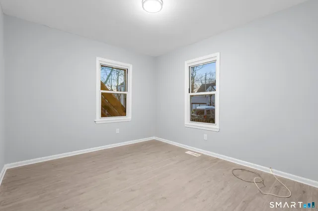 a kitchen with granite countertop a refrigerator stove and sink