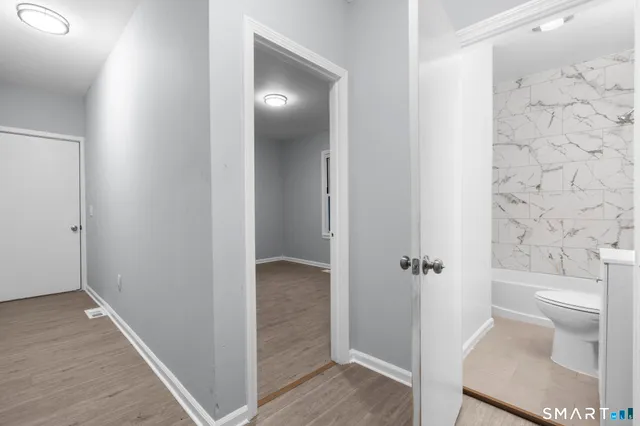 a large white kitchen with sink and window