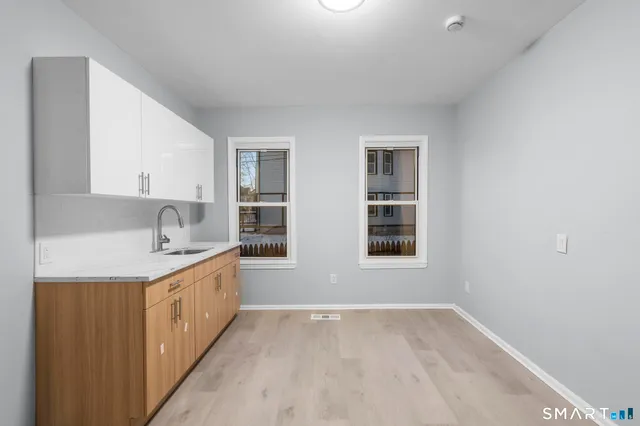 a kitchen with stainless steel appliances granite countertop a sink and a refrigerator