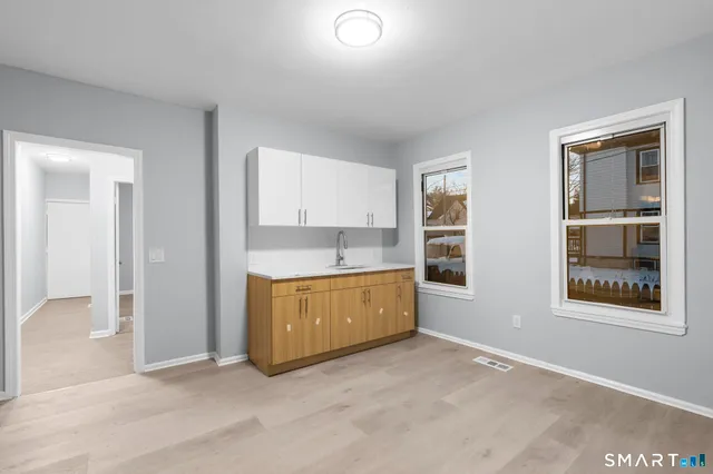 a kitchen with stainless steel appliances a refrigerator and a stove top oven