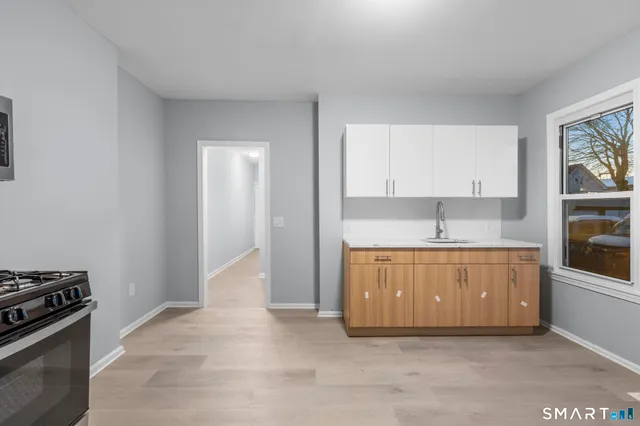 a kitchen with stainless steel appliances granite countertop a sink and a stove top oven