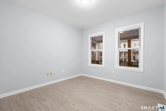 a view of an empty room with wooden floor