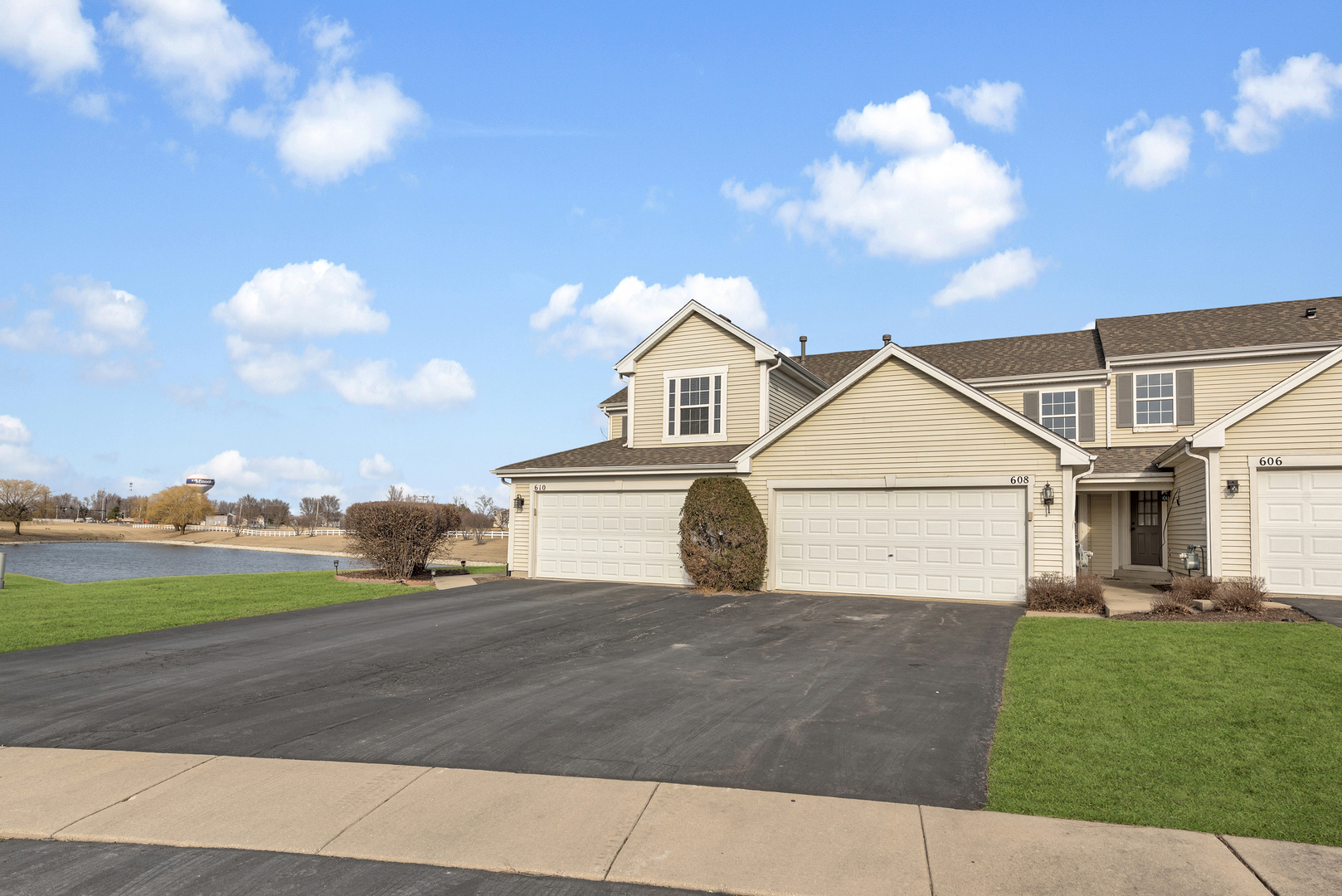 608 Chestnut Ridge Minooka, IL 60447 - Photo 2 of 16 a view of a white house next to a yard with big trees
