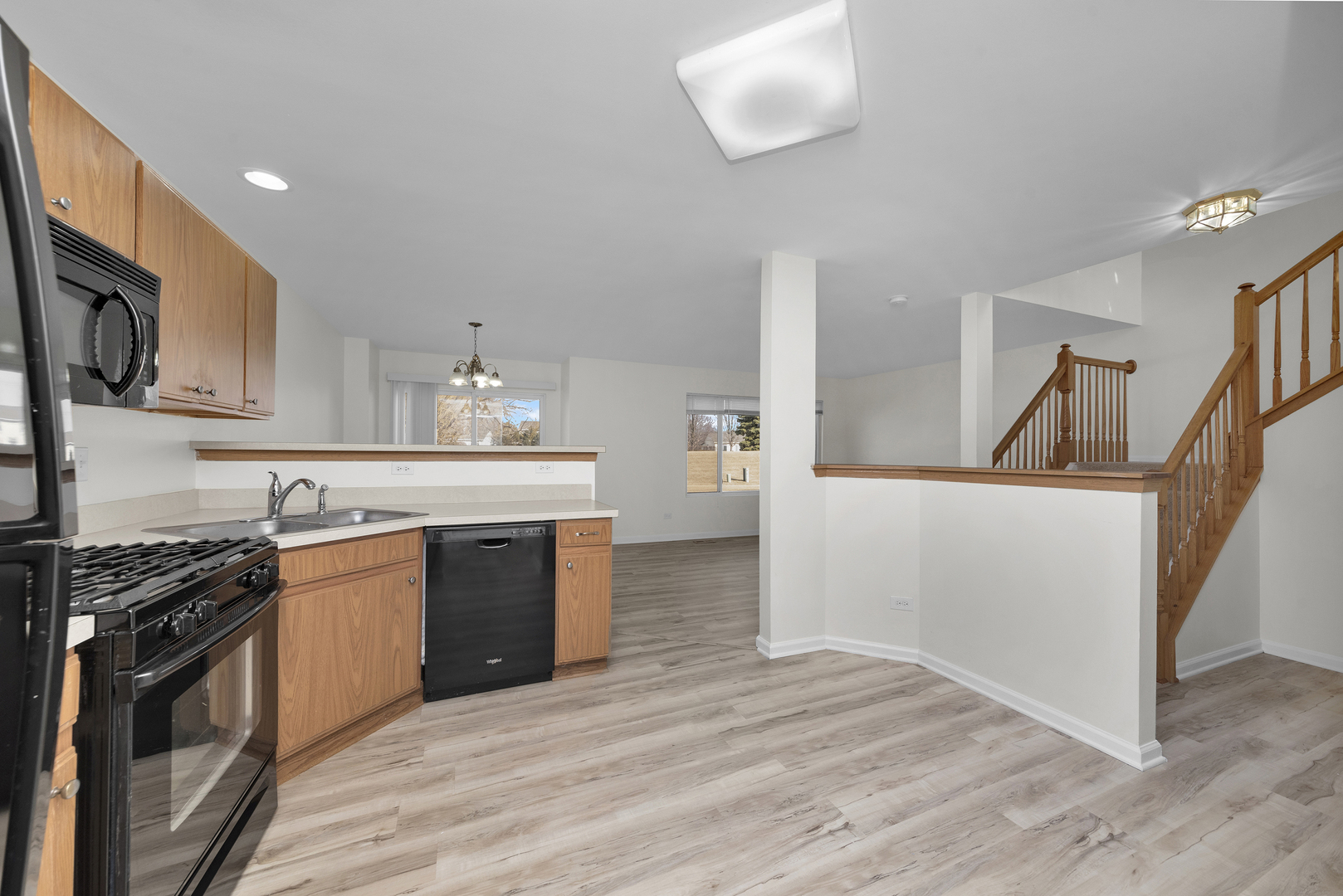 608 Chestnut Ridge Minooka, IL 60447 - Photo 4 of 16 a kitchen with stainless steel appliances granite countertop a stove and a sink