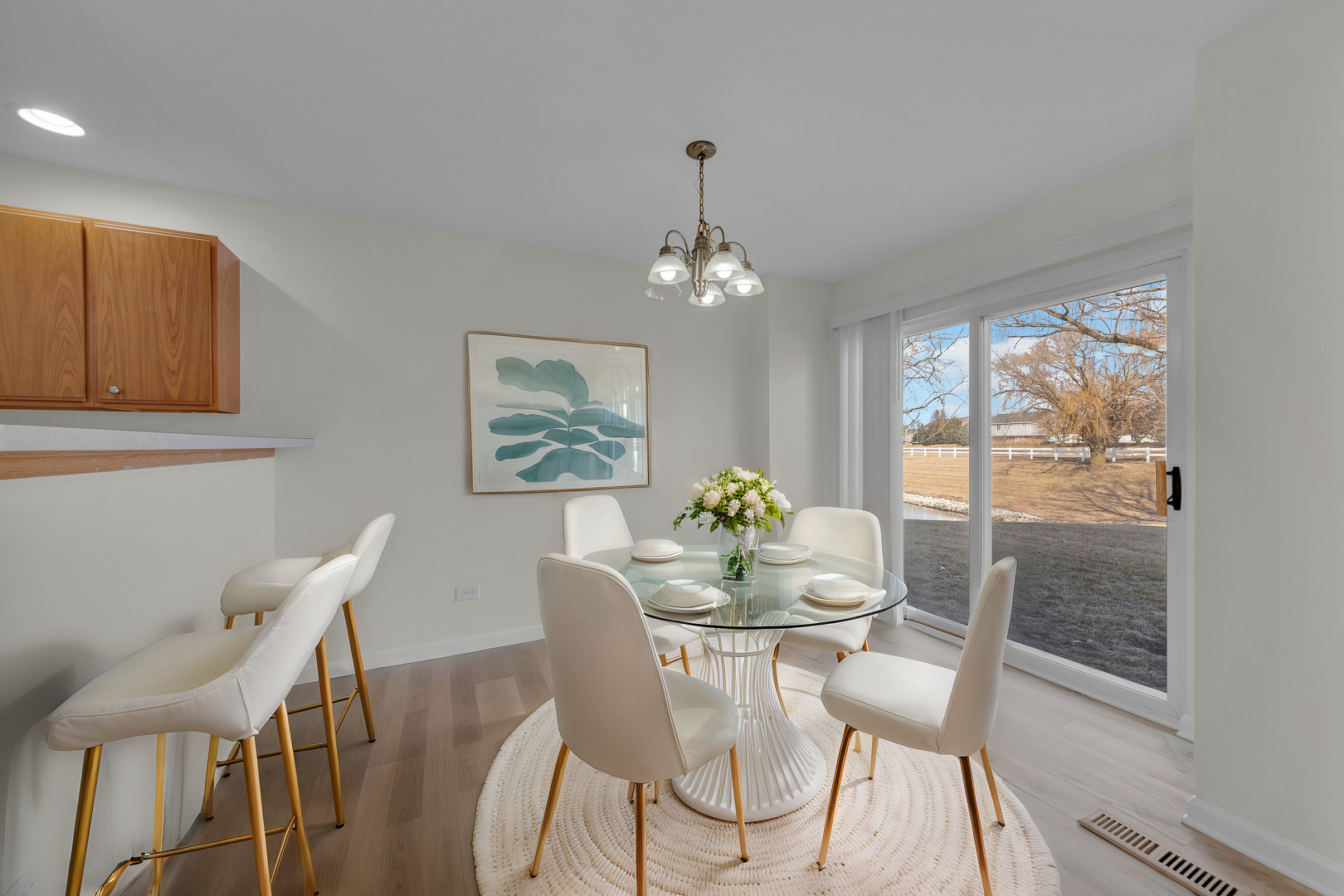 608 Chestnut Ridge Minooka, IL 60447 - Photo 5 of 16 a dining room with furniture a rug and a chandelier
