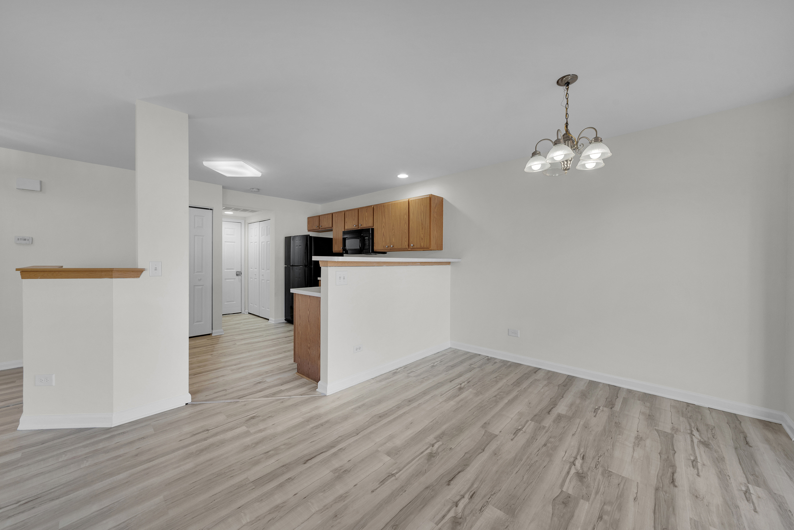 608 Chestnut Ridge Minooka, IL 60447 - Photo 6 of 16 wooden floor in an empty room with a window