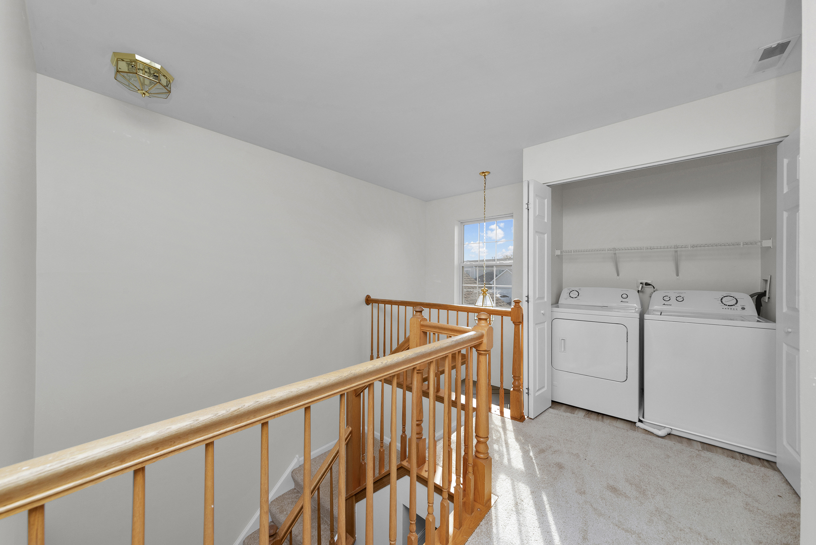 608 Chestnut Ridge Minooka, IL 60447 - Photo 10 of 16 a view of a hallway with washer and dryer