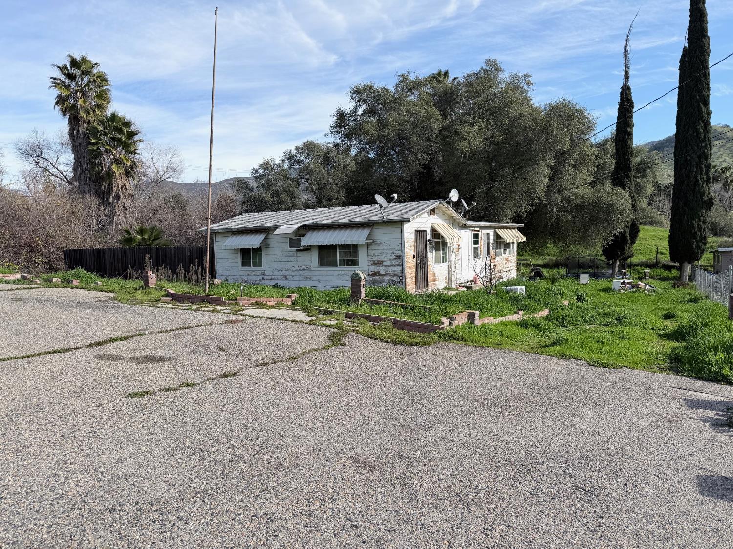 35415 Highway 190 Springville, CA 93265 - Photo 3 of 17 a front view of a house with a yard and garage