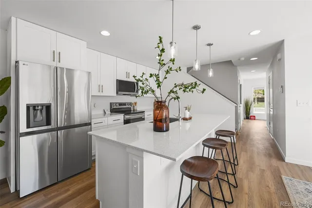 a kitchen with stainless steel appliances a refrigerator and a stove