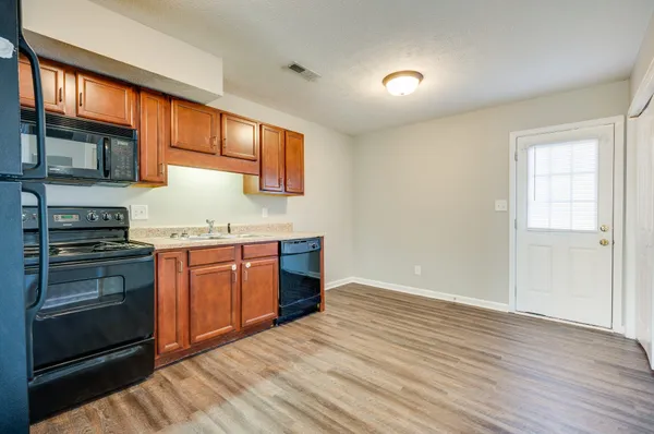 a kitchen with granite countertop stainless steel appliances and wooden cabinets