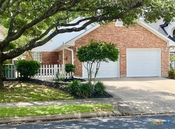 a front view of a house with a yard garage and outdoor seating
