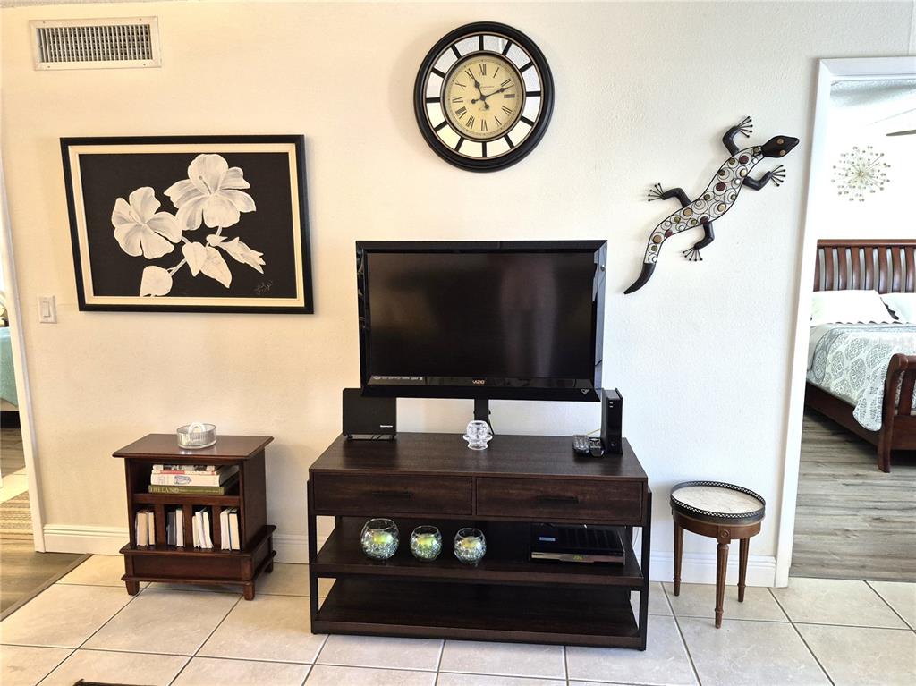 107 Windward Place, Unit 107 Oldsmar, FL 34677 - Photo 8 of 34 a living room with furniture and a flat screen tv