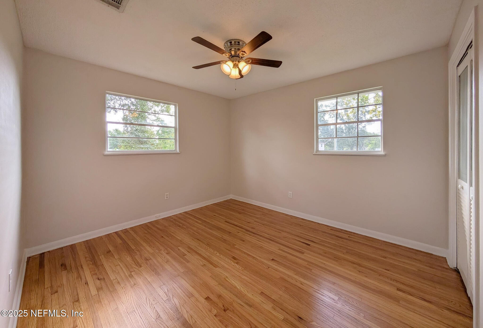 5091 Somersby Road Jacksonville, FL 32217 - Photo 11 of 19 a view of an empty room with wooden floor and a window