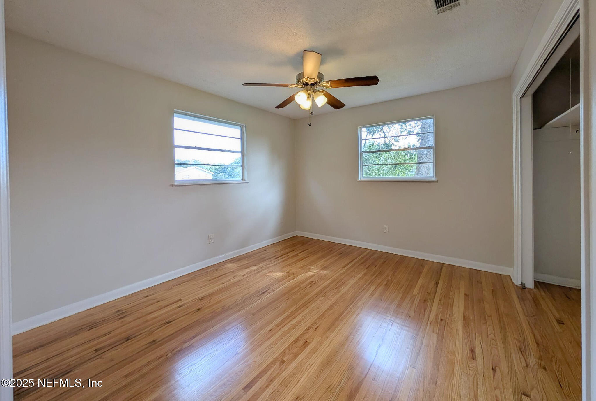 5091 Somersby Road Jacksonville, FL 32217 - Photo 12 of 19 wooden floor in an empty room with a window