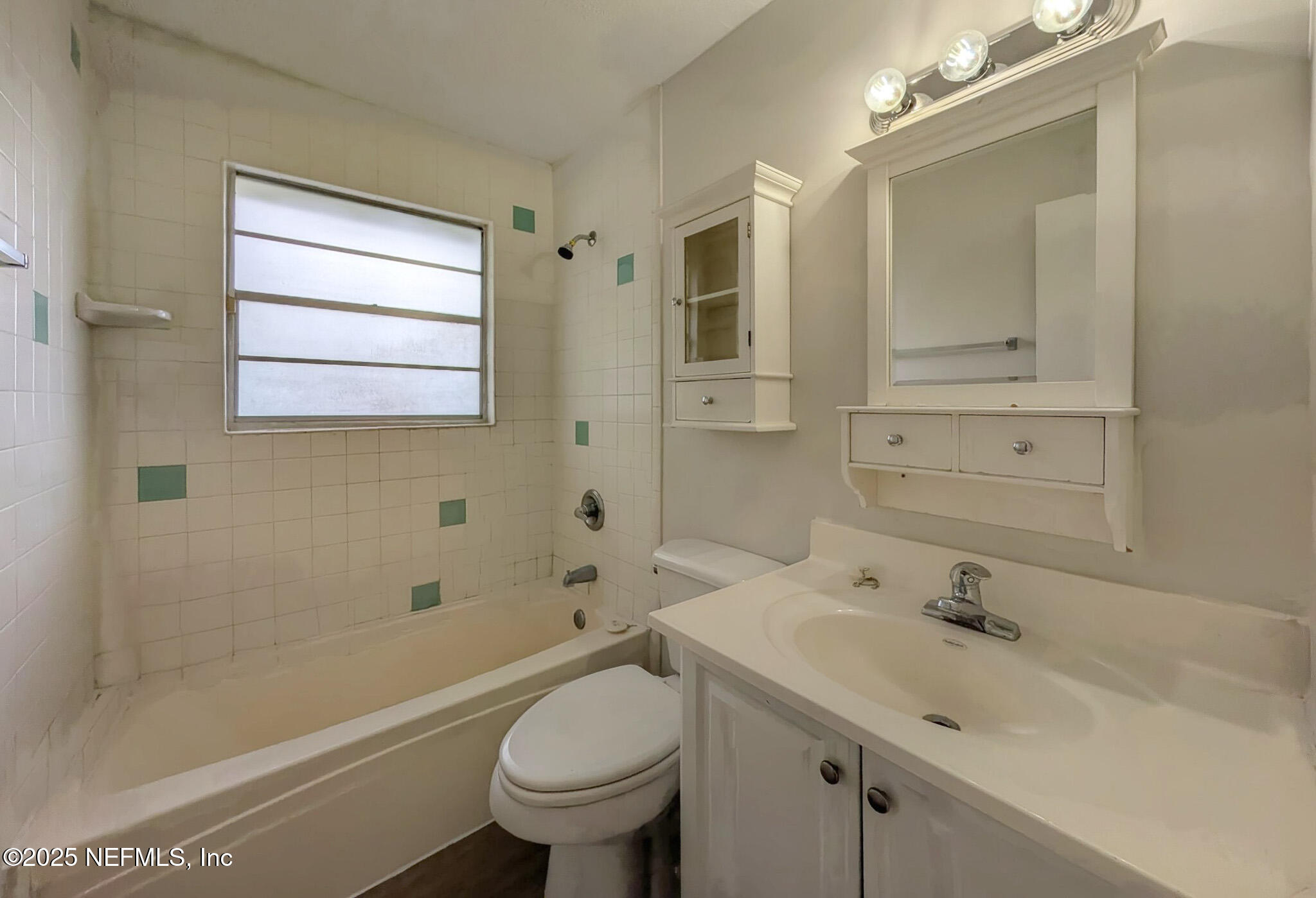 5091 Somersby Road Jacksonville, FL 32217 - Photo 13 of 19 a bathroom with a sink a toilet and shower