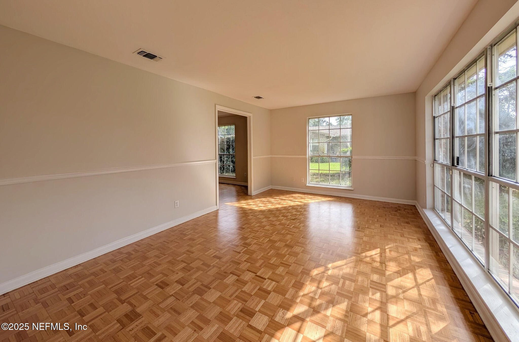 5091 Somersby Road Jacksonville, FL 32217 - Photo 3 of 19 wooden floor in an empty room with a window