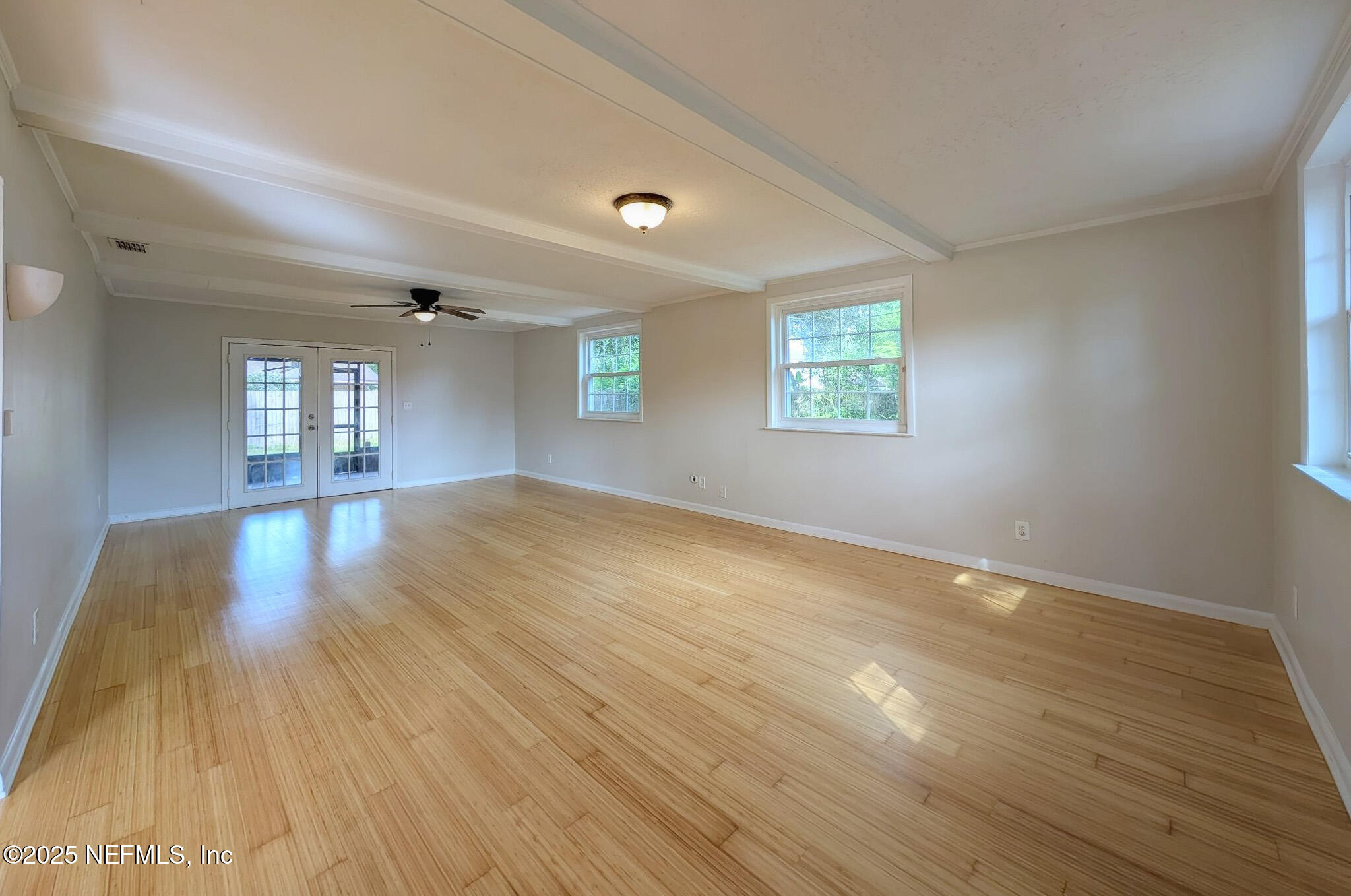 5091 Somersby Road Jacksonville, FL 32217 - Photo 5 of 19 an empty room with wooden floor and windows