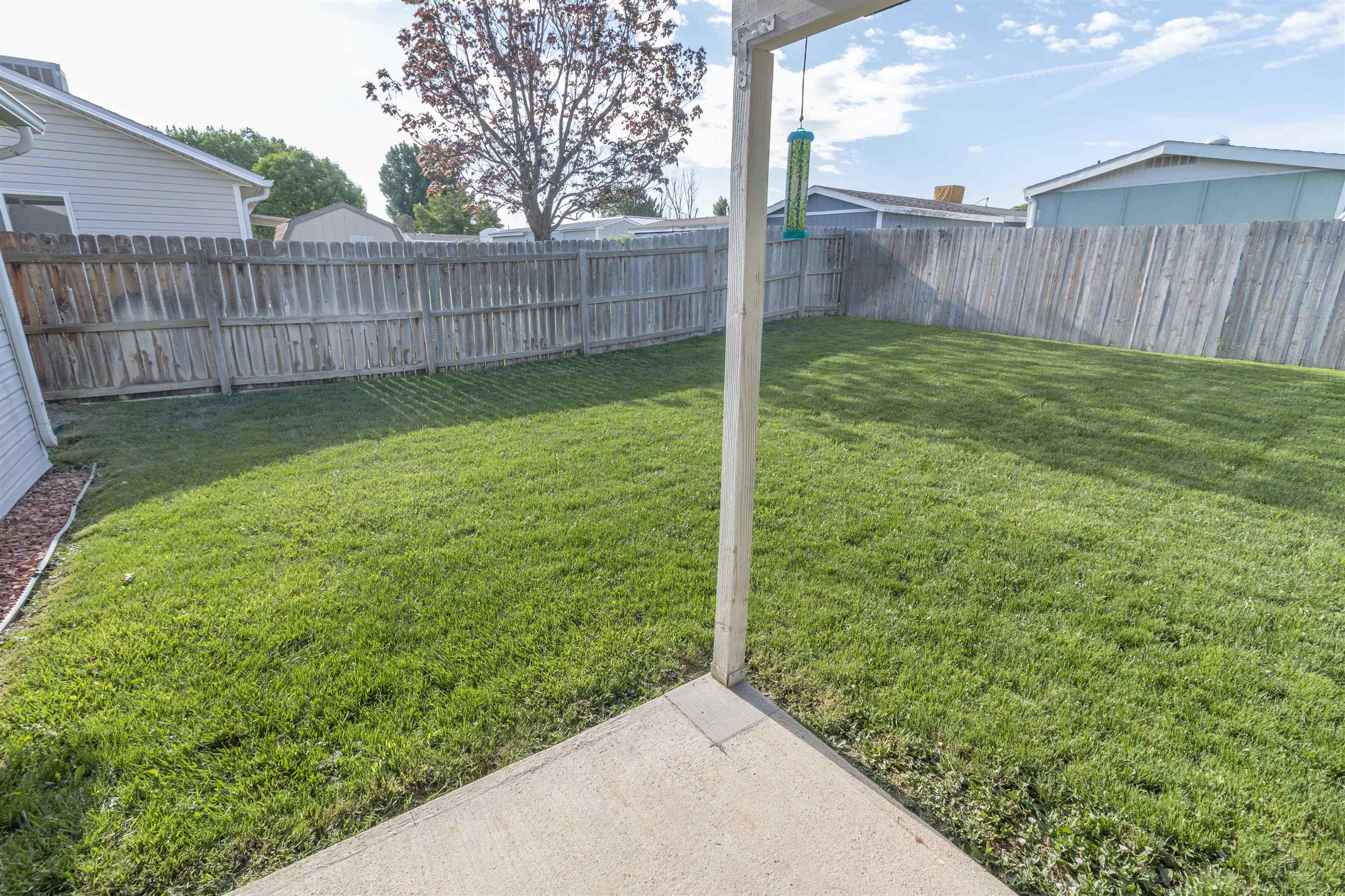 1386 Powell Street Fruita, CO 81521 - Photo 18 of 21 a view of a backyard with a fence