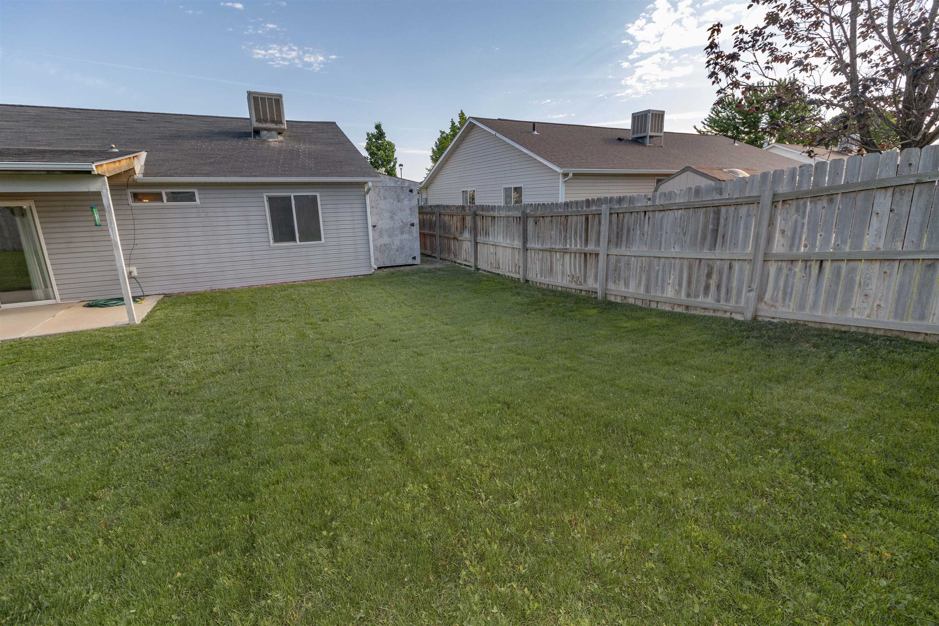 1386 Powell Street Fruita, CO 81521 - Photo 20 of 21 a view of a house with a yard and wooden fence